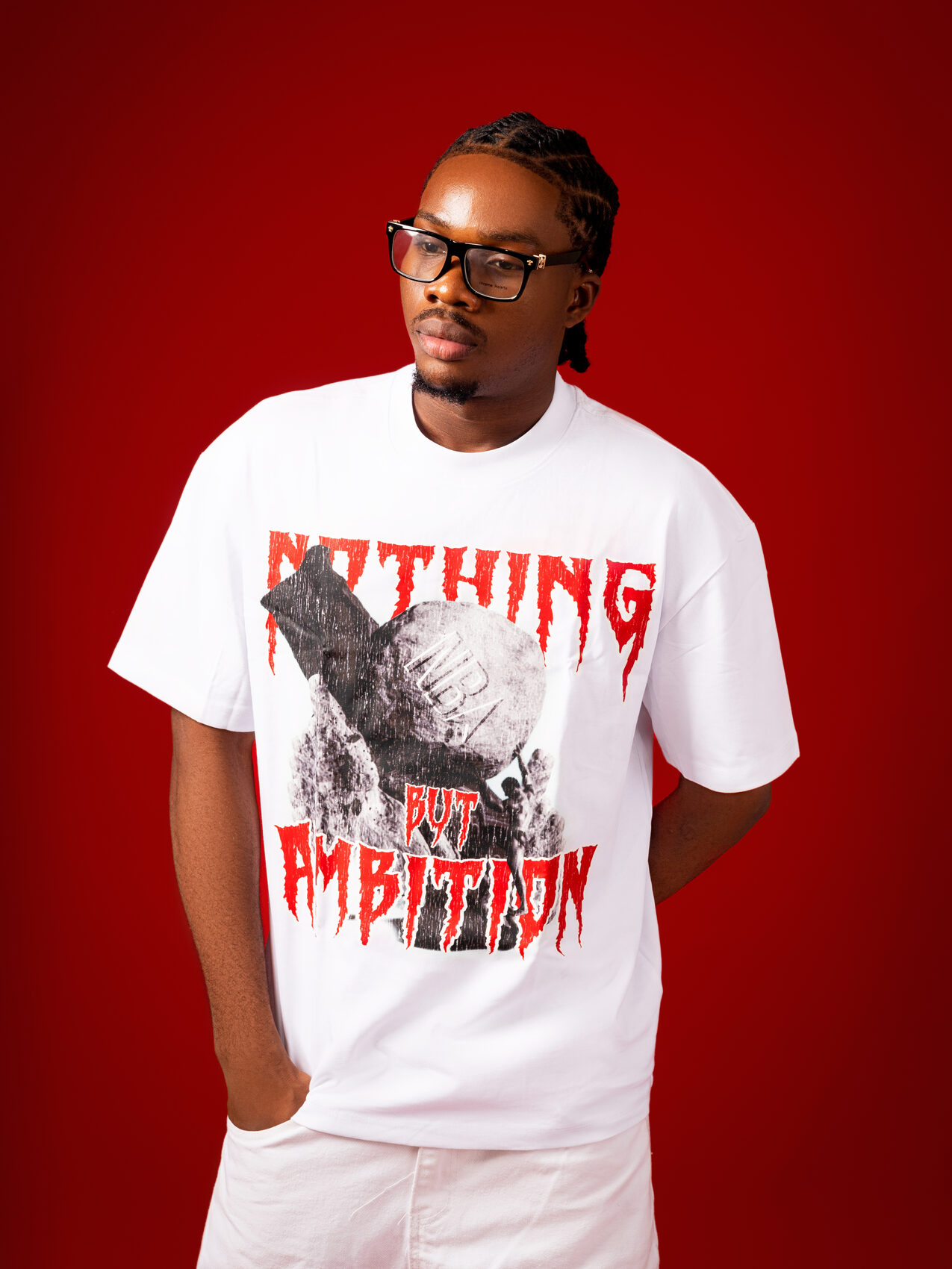Model wearing the white NBA graphic tee, on a red studio backdrop