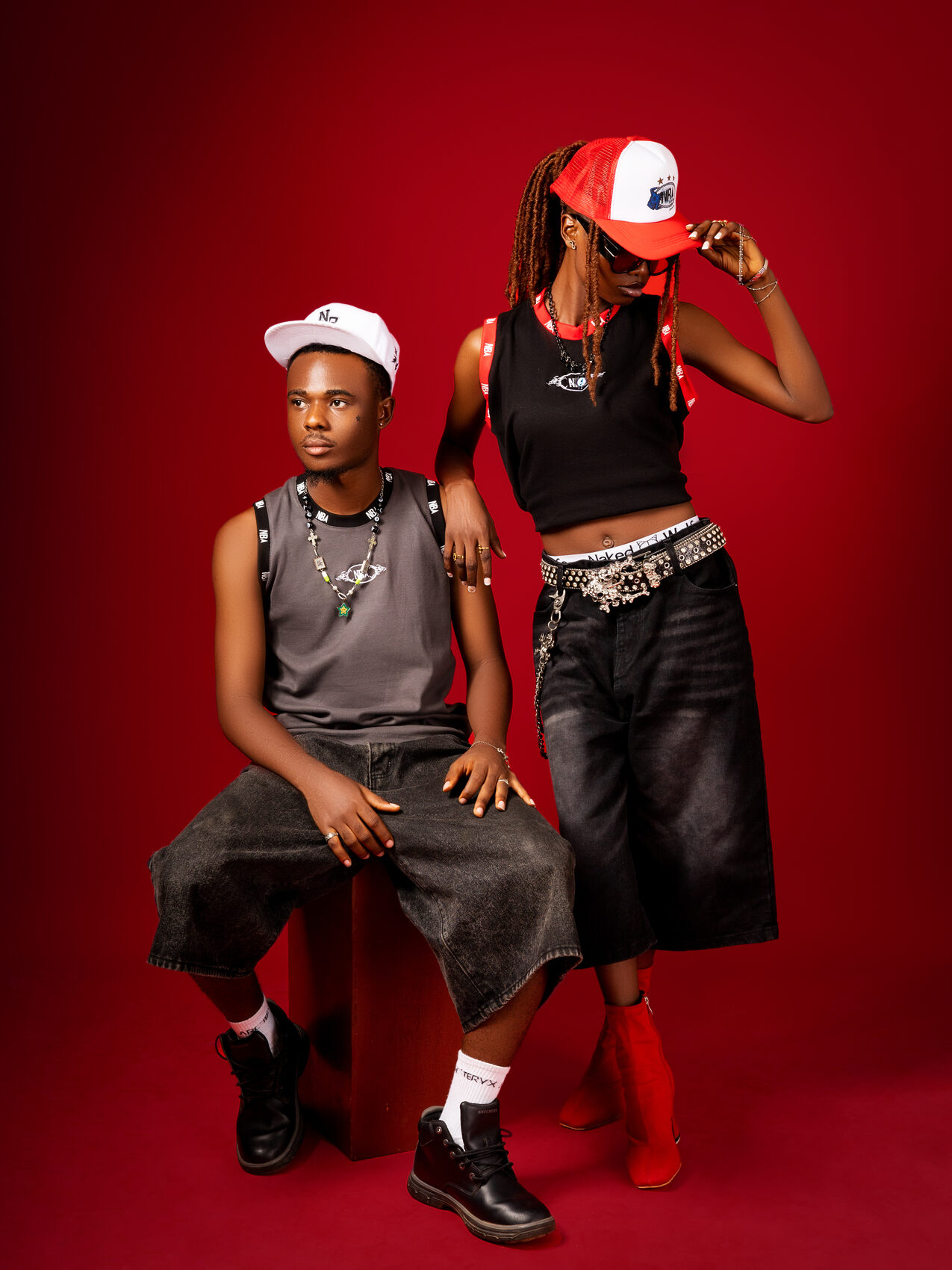 Two models wearing NBA essential tank tops in grey and black, studio shot